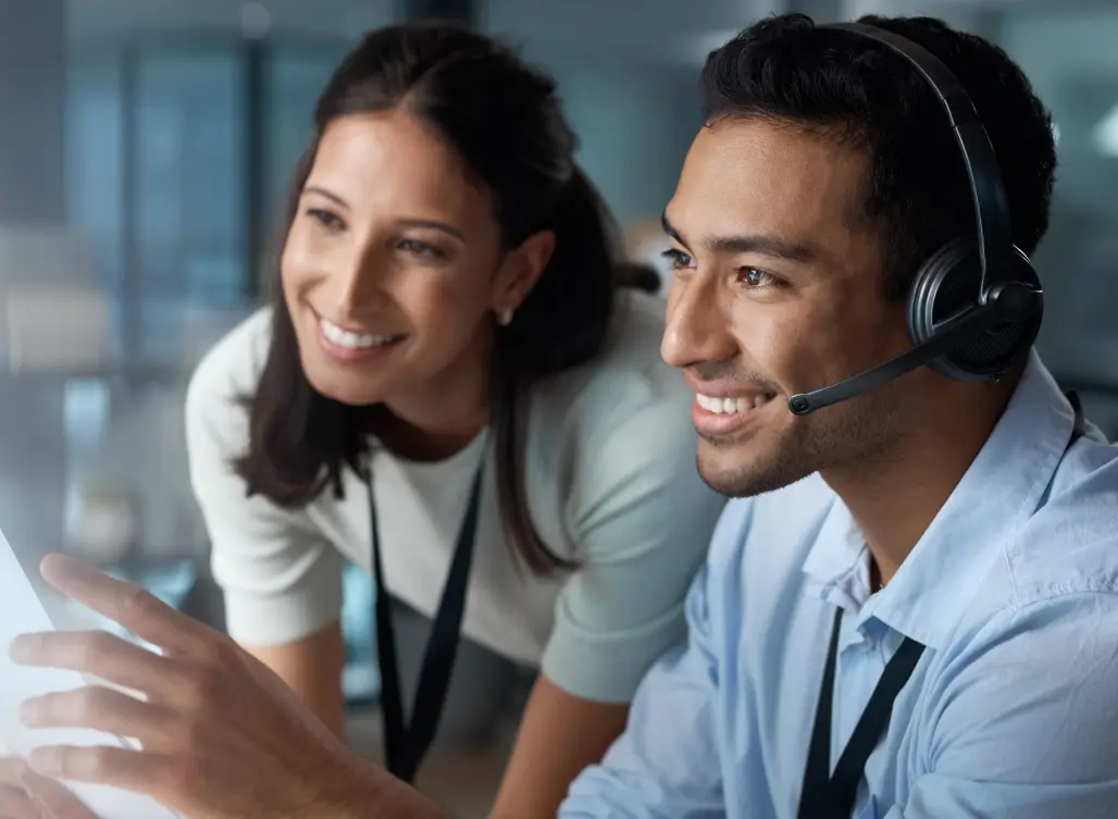 Shot of a young man and woman using a computer while working in a call center